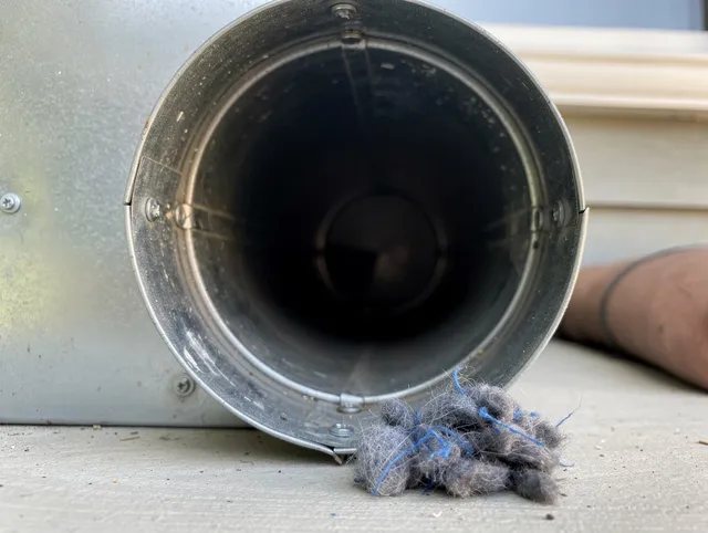 Margate Dryer Vent Cleaning technician using specialized equipment to clear severe dryer vent blockage in Margate